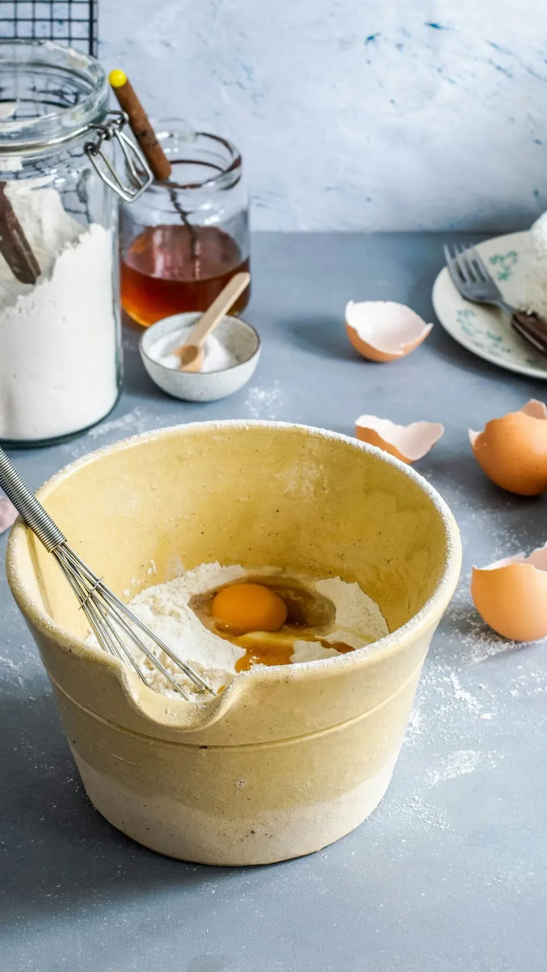 un bol avec les ingrédients pour faire des crêpes sur un plan de travail