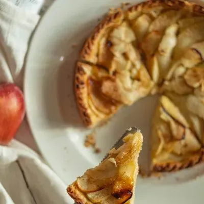 une tarte aux pommes avec une part coupée