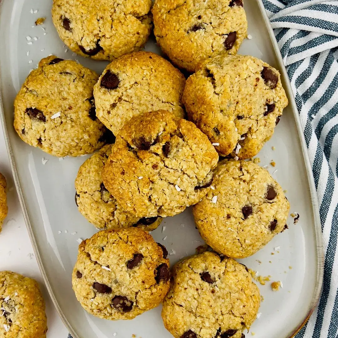 Cookies au chocolat et noix de coco des cookies chocolat coco sur un plat avec un torchon sur le côté