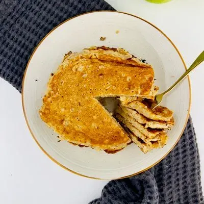 des pancakes aux pommes coupés sur une assiette