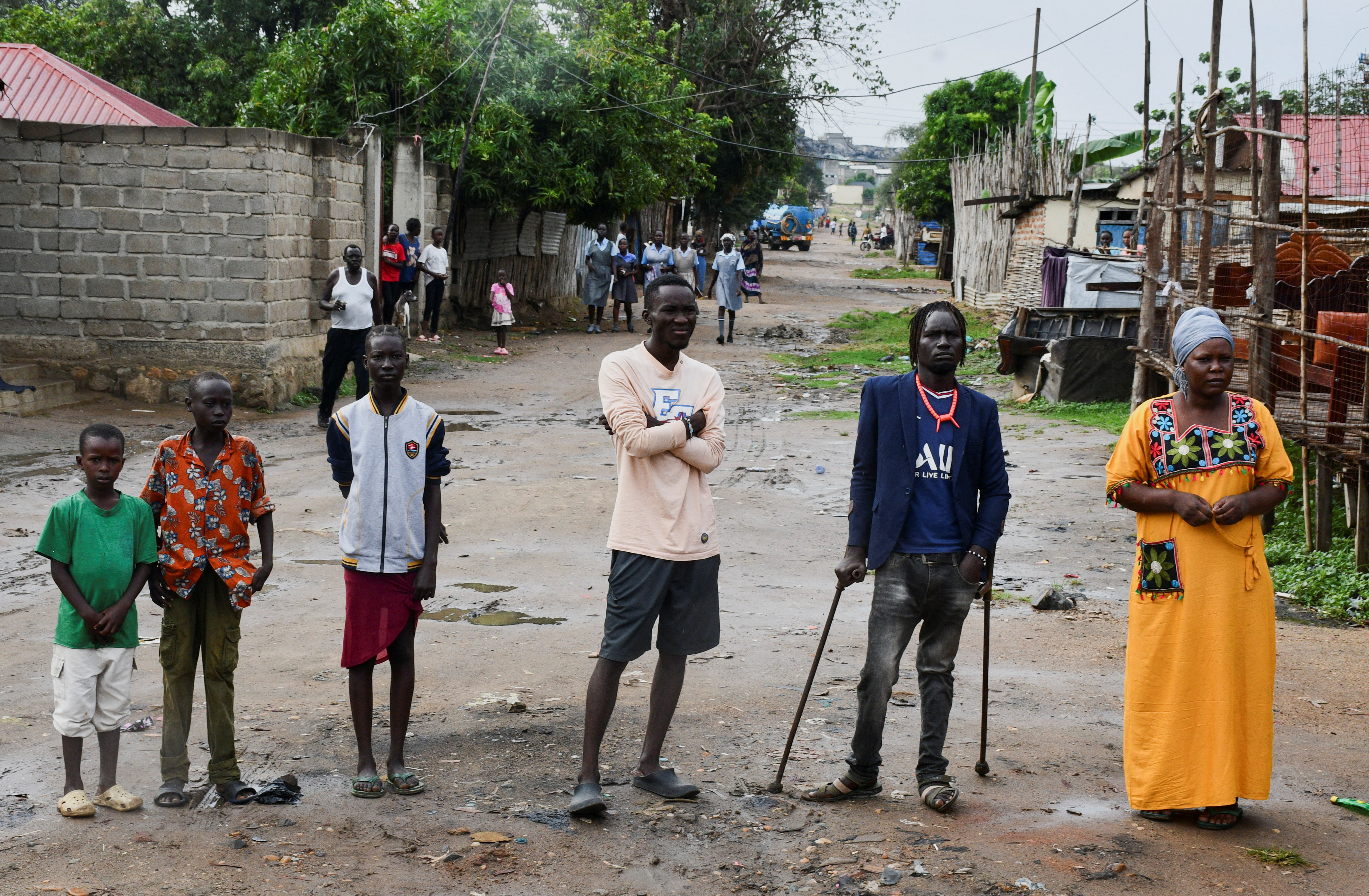 Pedestrians walking past political signboards in Juba, South Sudan.