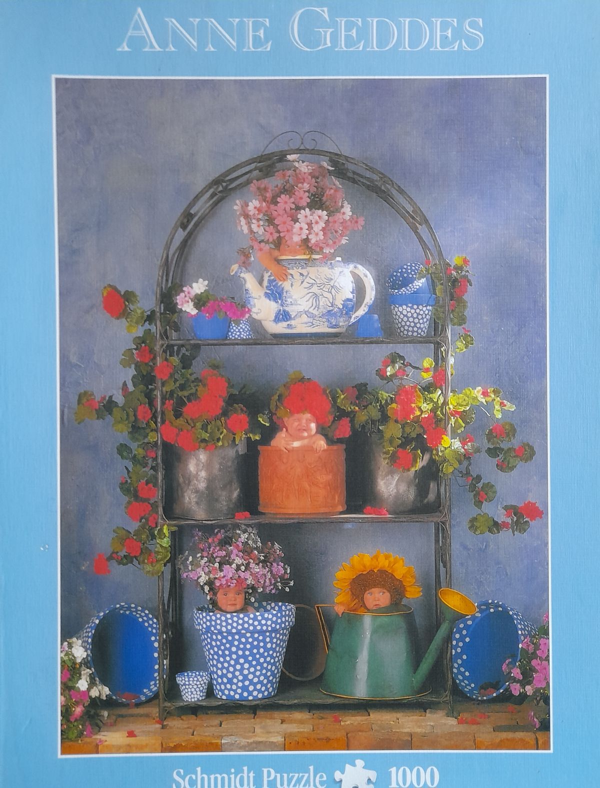 Puzzle: Anne Geddes Blumenregal von Schmidt Puzzle (1000 Teile) - Wanderpuzzle