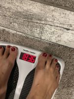 Kat standing on a digital scale showing 183.6 pounds.