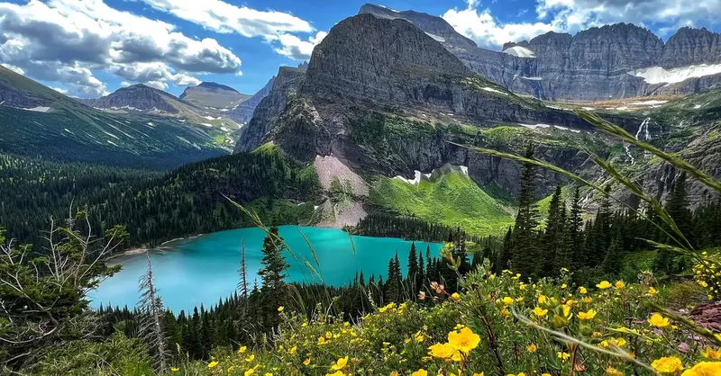 Turquoise alpine lake surrounded by steep mountain walls at Glacier National Park