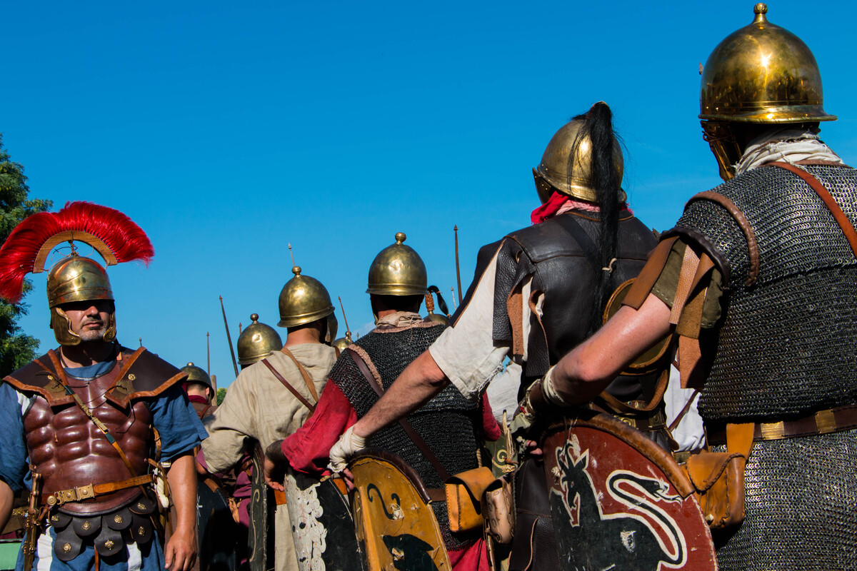 Picture of reenactment with people dressed as roman soldiers and a centurion inspecting them