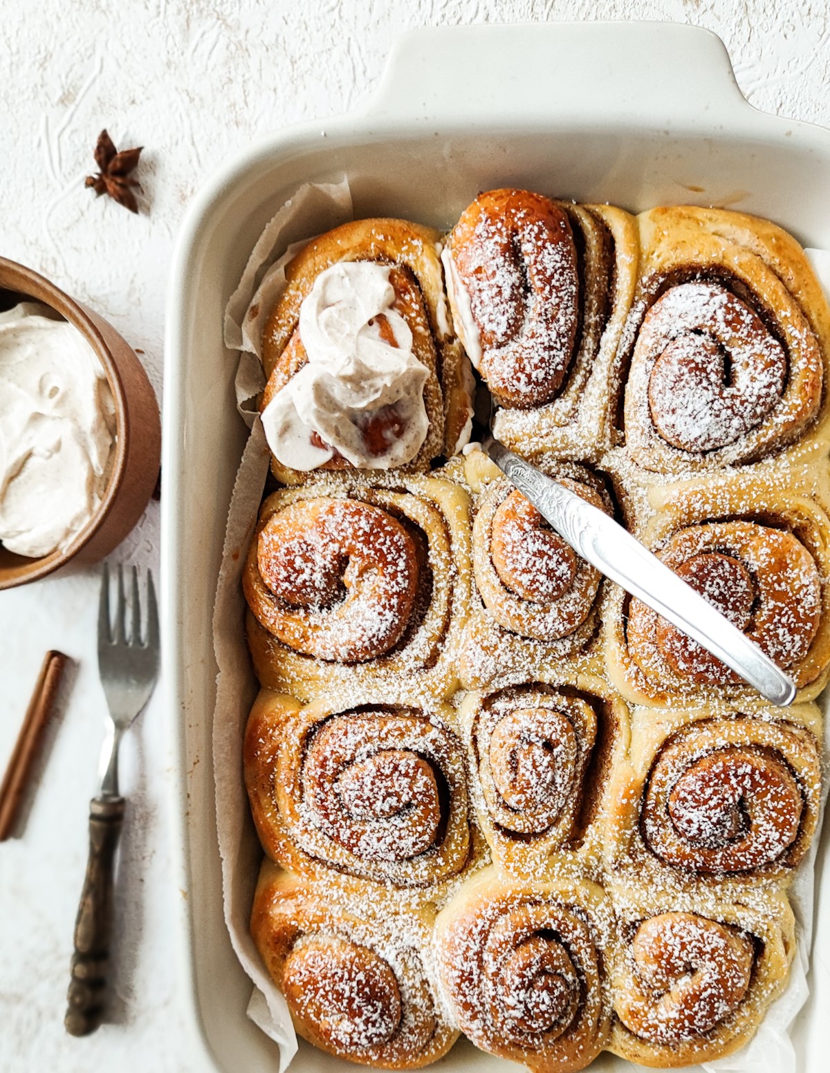 Milk bread cinnamon rolls in a white baking tray