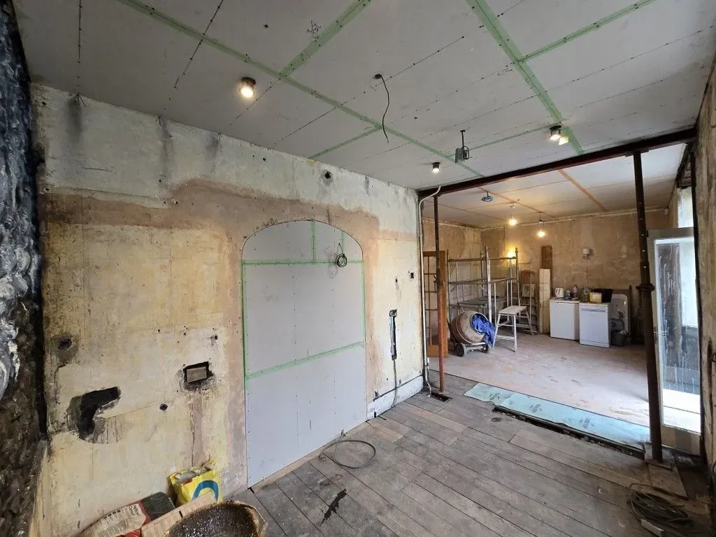 Extensive residential renovation in Redland showing structural props, ceiling boarding, and site equipment ready for full-room skimming.