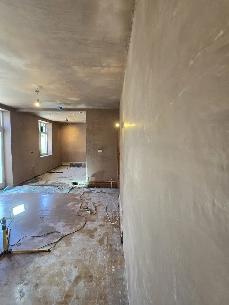 Freshly skimmed plaster finish on walls and ceiling with lights shining on them  of a large open-plan kitchen-diner renovation in Redland, Bristol BS6.