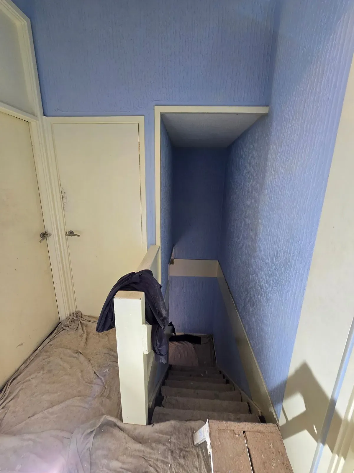 Artex removal on a staircase bulkhead and landing area before professional skimming