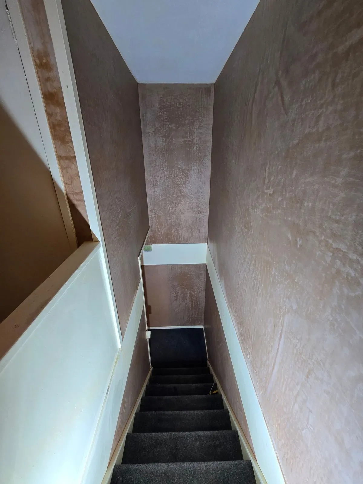 Smooth skimmed walls in a narrow stairwell after Artex removal project BS30
