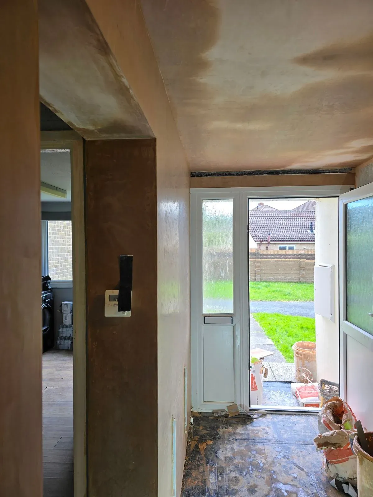 alt="Full view of a long hallway wall professionally skimmed for a smooth paint-ready finish"