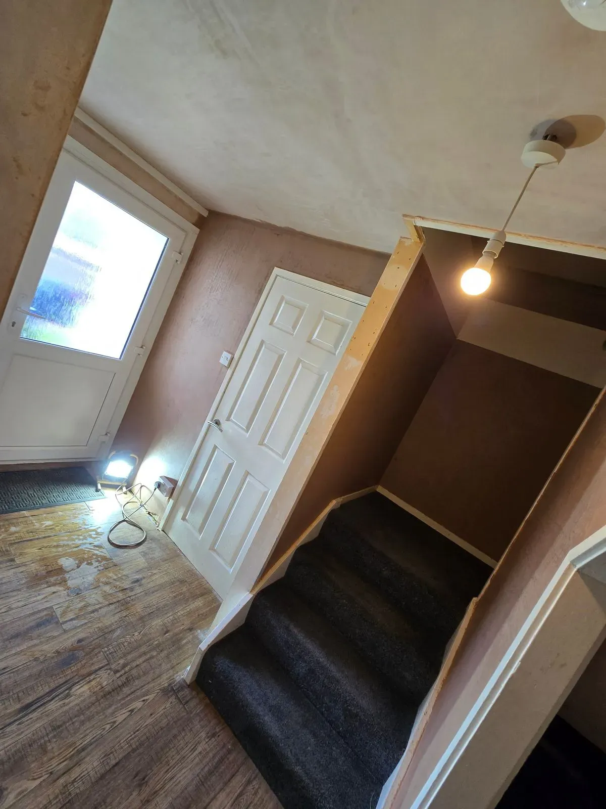 Clean plastered lines and sharp angles on a staircase bulkhead after professional skimming