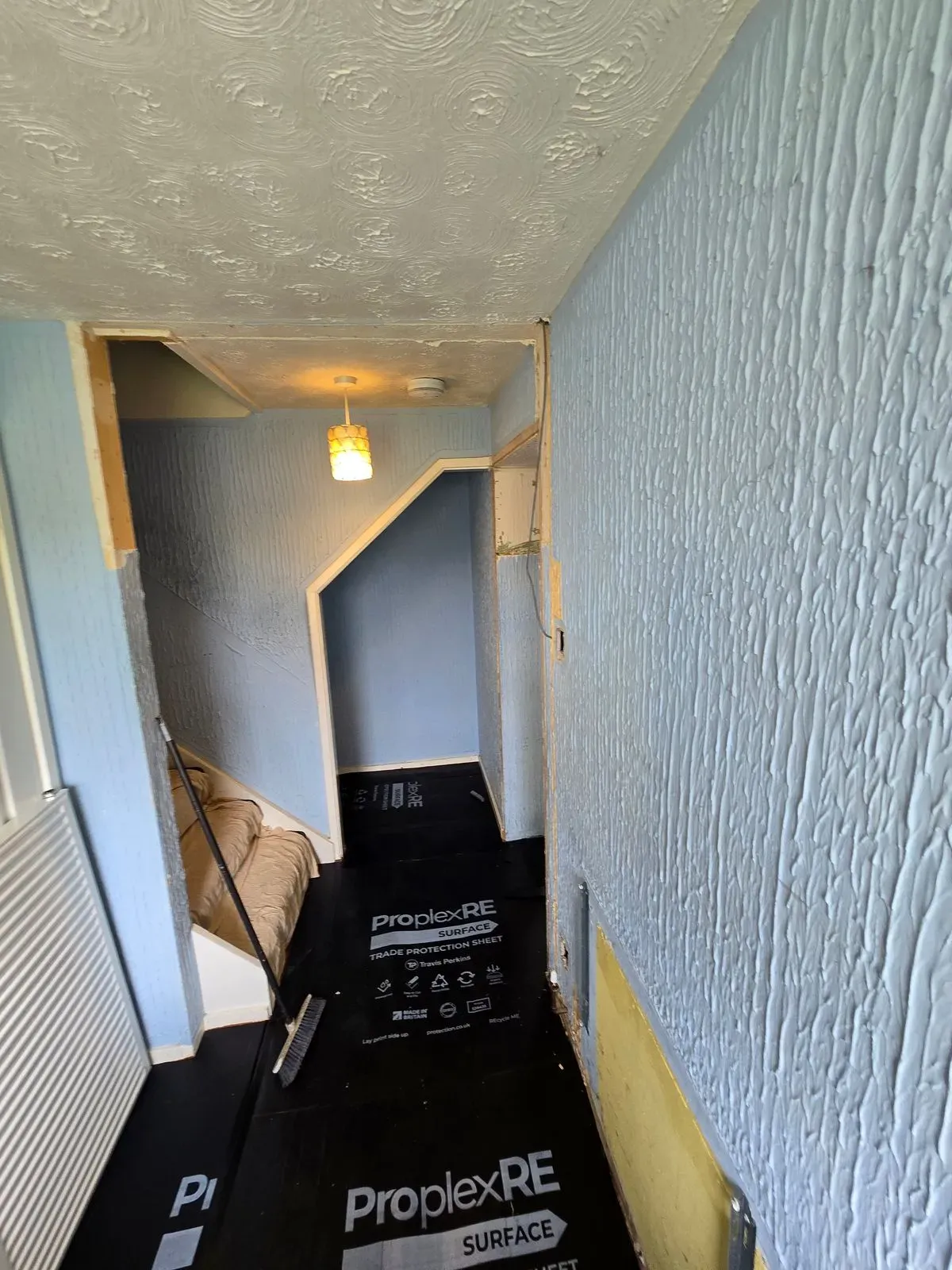 Dated Artex hallway walls and ceiling in Cadbury Heath home before plastering renovation