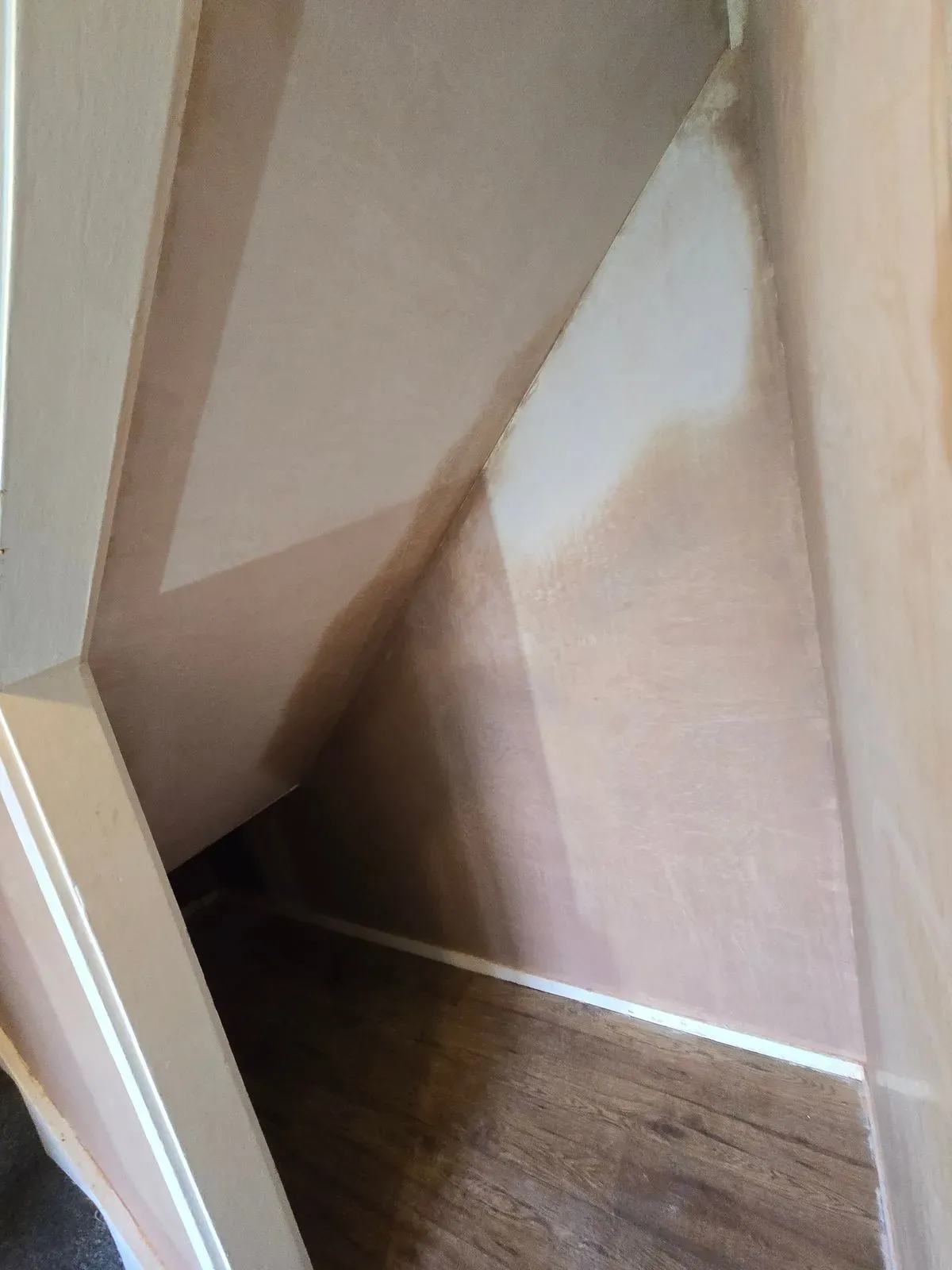 Internal view of a smooth skimmed under-stairs storage area in a Bristol home