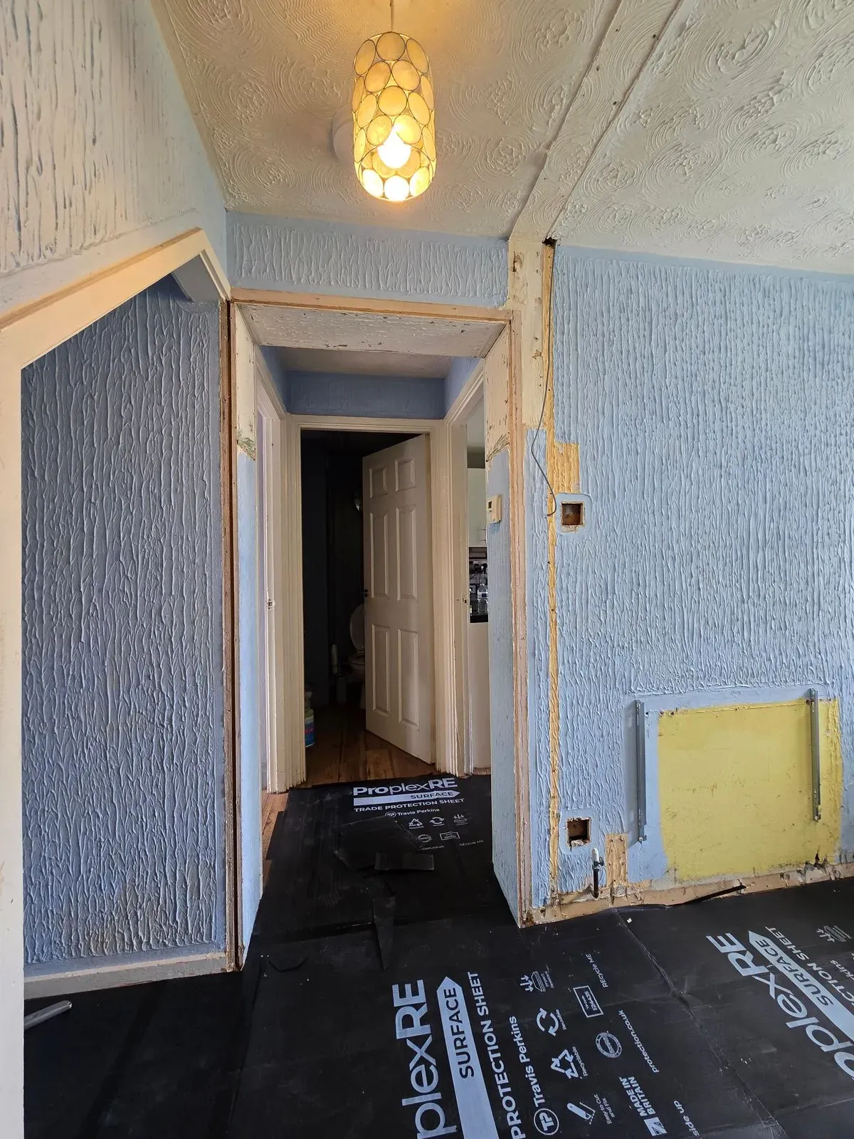 Heavy Artex pattern on hallway walls in BS30 before scraping and flattening prep