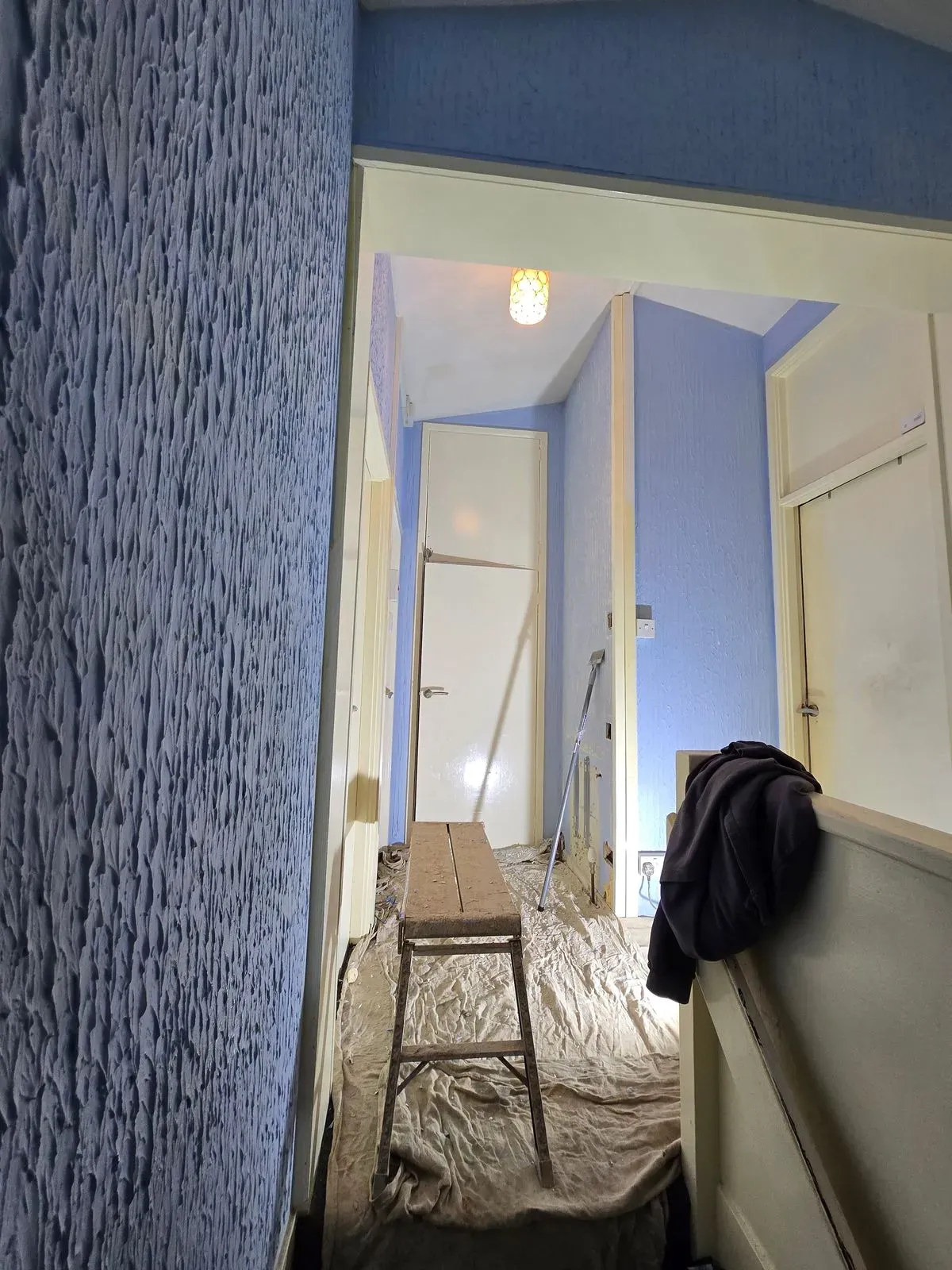 Close-up of heavy Artex texture on walls before professional plasterer begins scraping prep