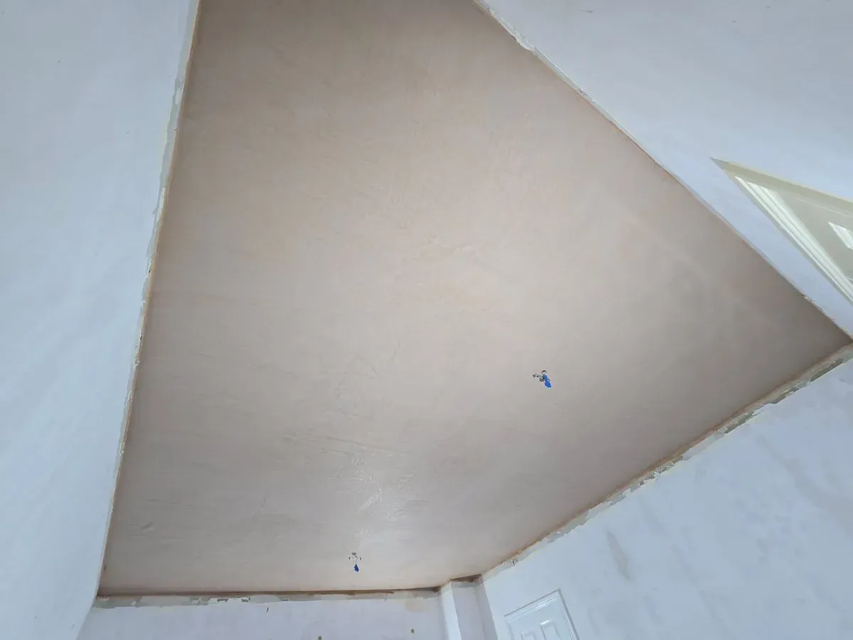 Smooth two-coat multi-finish plaster skimming on a large living room ceiling in Lympsham bs24
