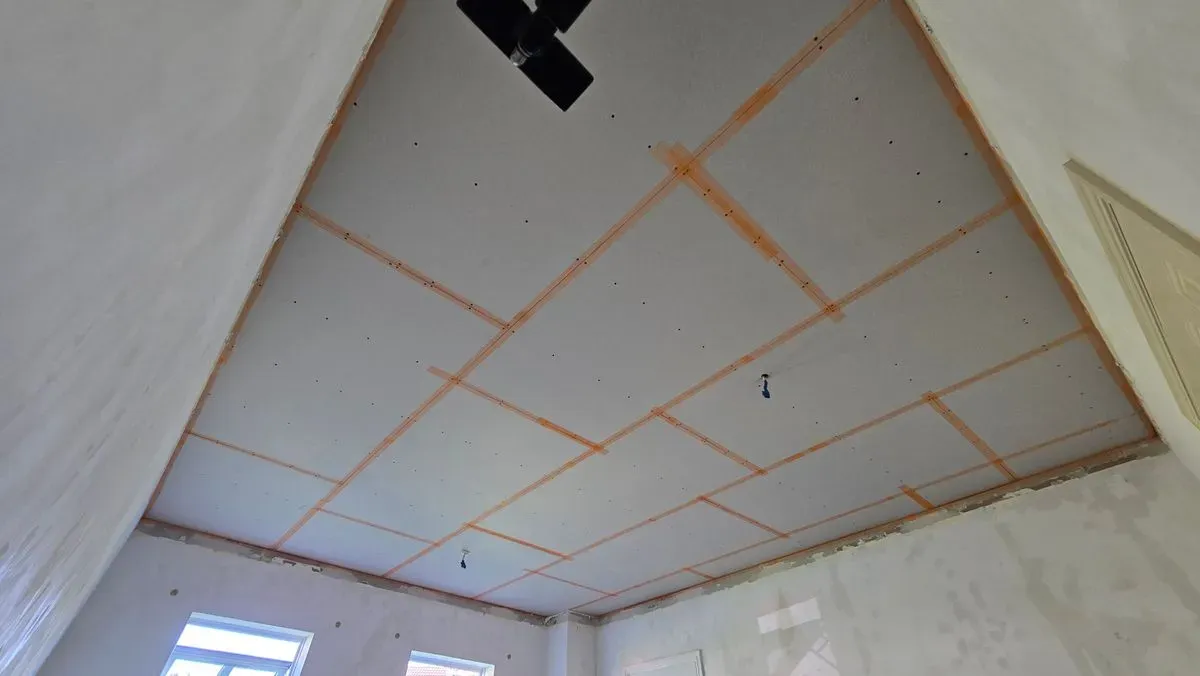 Replaced water-damaged ceiling with high-quality plasterboard, ready for a multi-finish coat.
