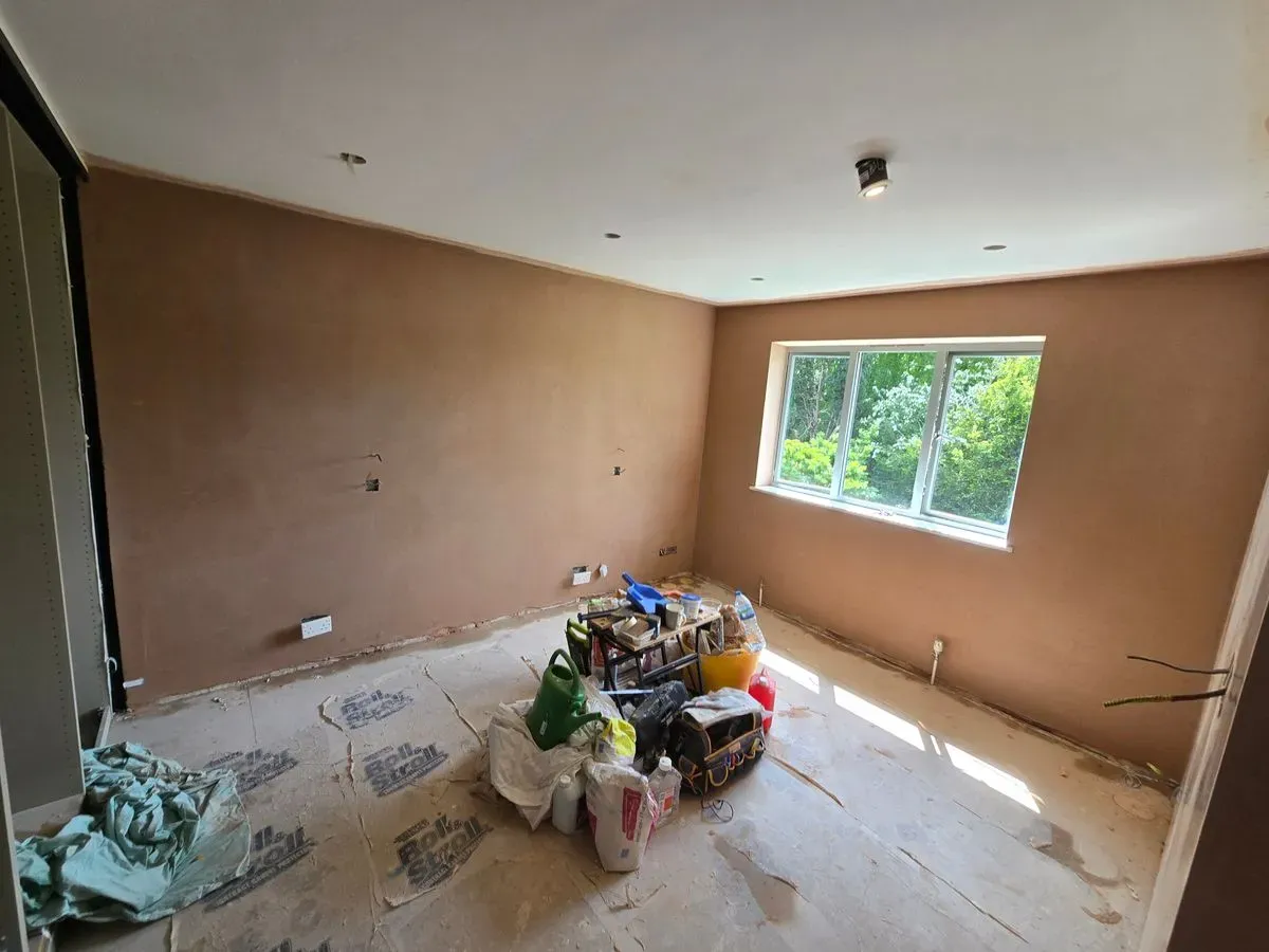 Full view of a master bedroom skimmed by JNS Plastering, highlighting the high-quality finish and clean workspace.