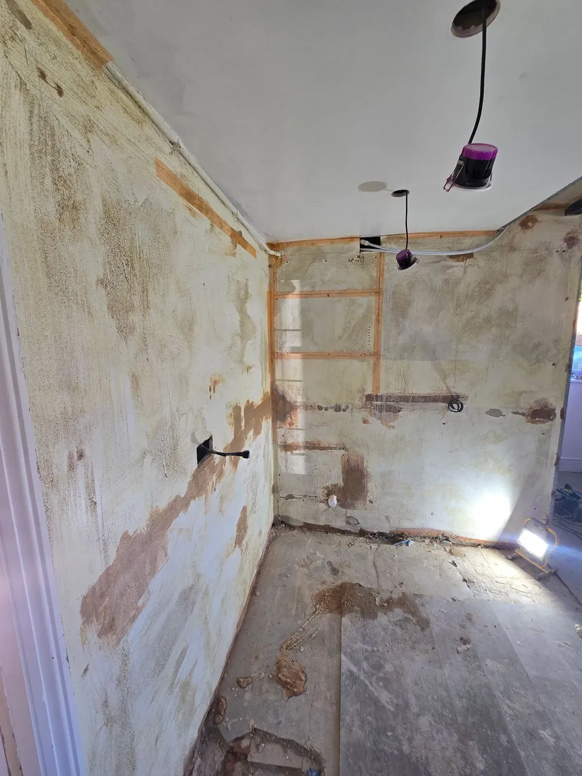 Yellow grit bonding agent applied to kitchen walls for plastering in Rangeworthy Bristol