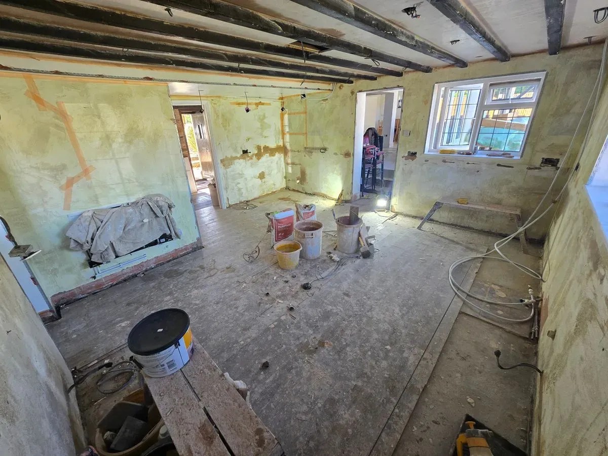 Kitchen plastering preparation in Rangeworthy applied yellow grit and metal angle beads around windows Bristol showing ceiling beams and stripped walls