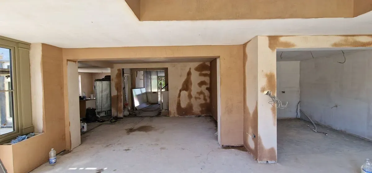 Professional plastering prep in Almondsbury: applying blue grit window beads and scrim tape to walls and joins.