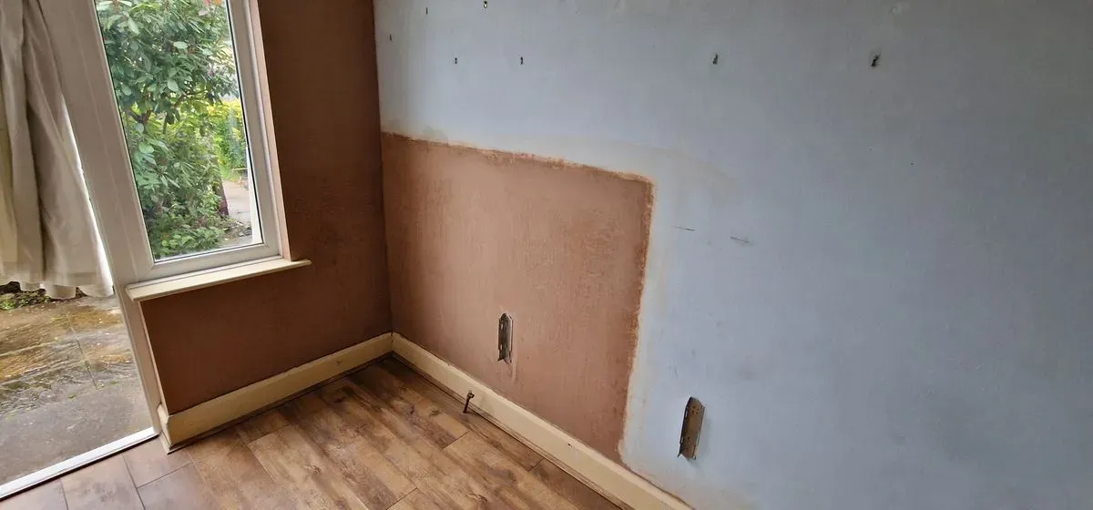 local job in Filton Bristol damp wet render removed and a new DPC cream damp course installed at floor level