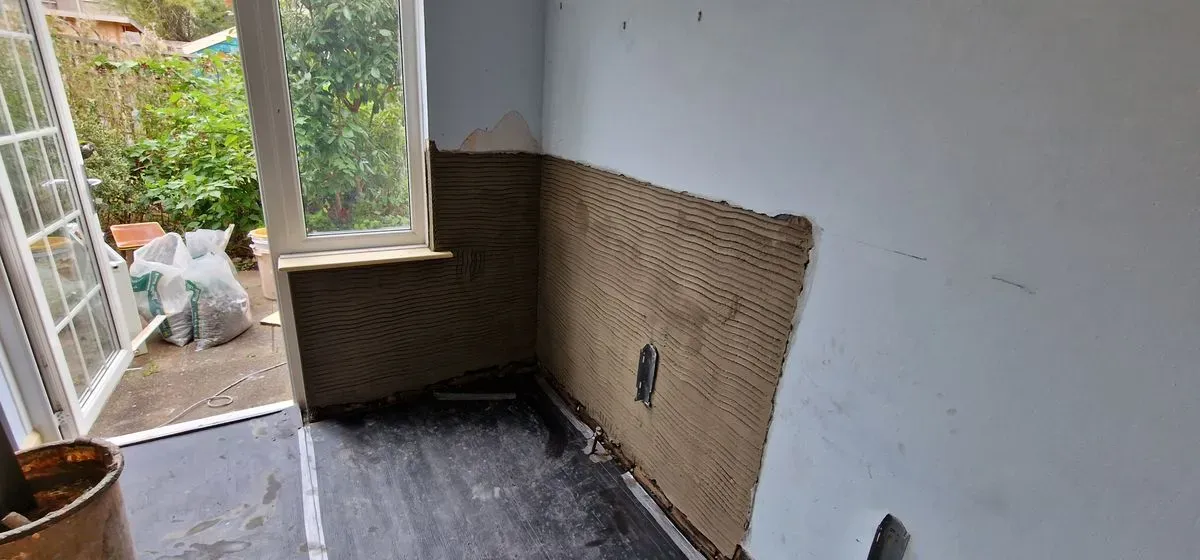local job in Filton Bristol damp wet render removed and a new DPC cream damp course installed at floor level