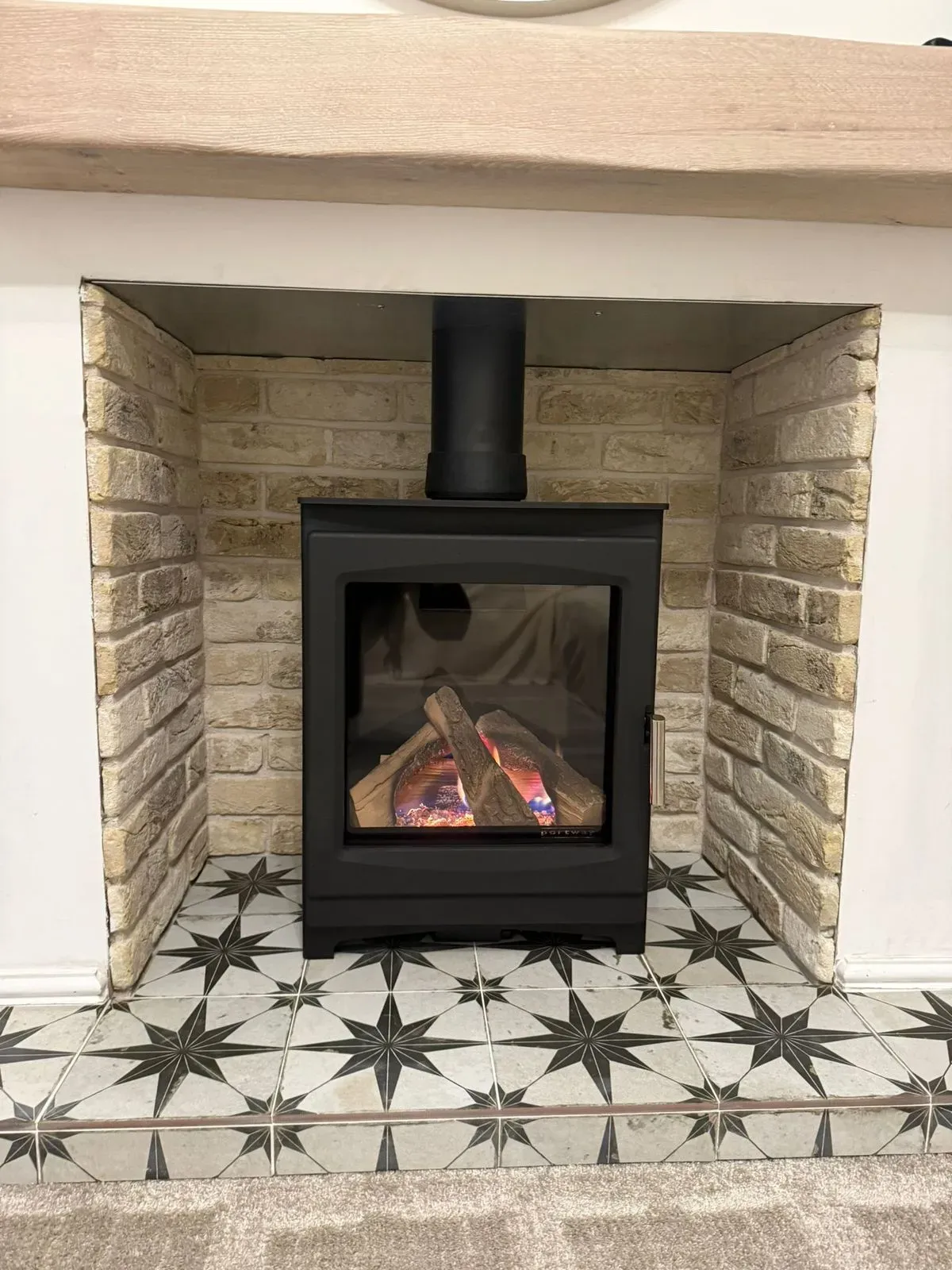 custom tiled hearth made with customers tiles with Luzimas gas stove from Rugeley Fireplaces Rugeley near Lichfield 