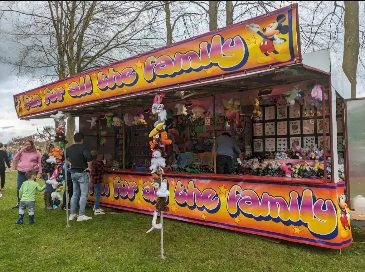 Families enjoying rides at a community fair in Leeds