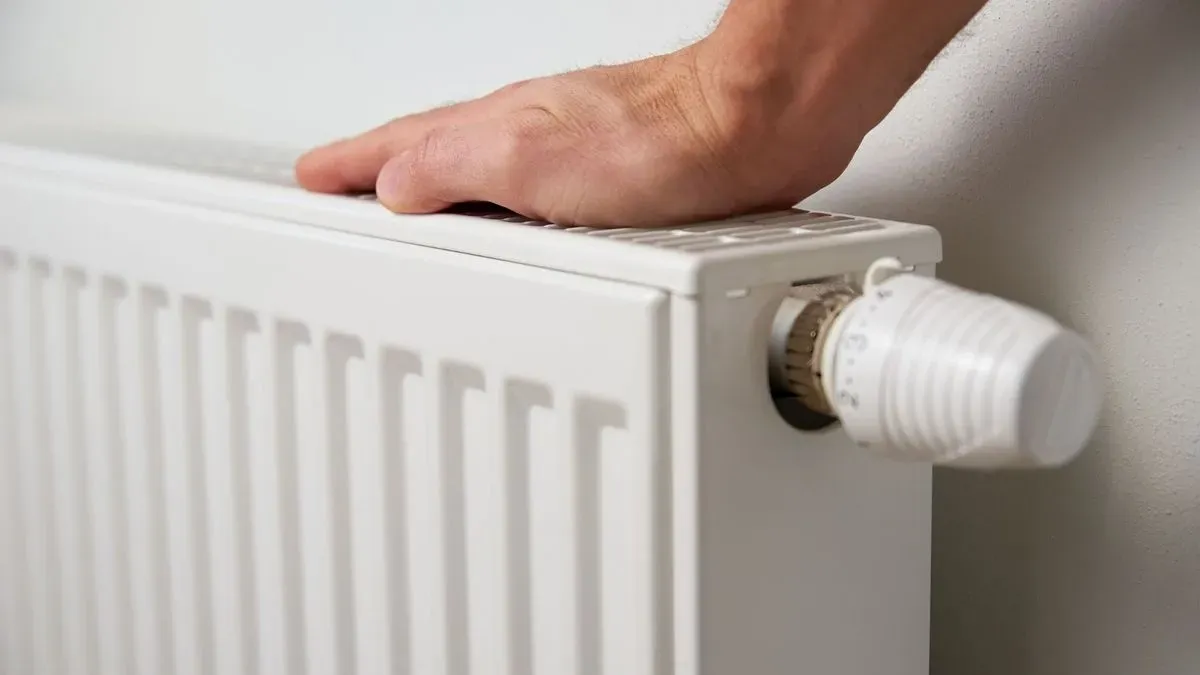 Safety check during radiator installation in Clapham