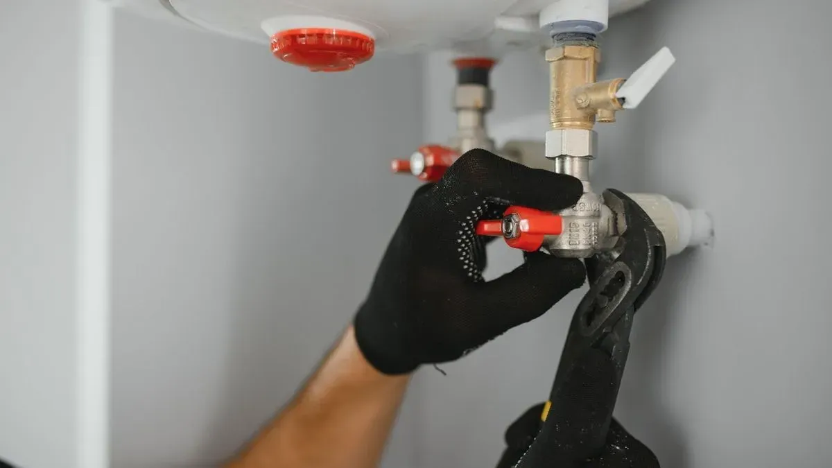 Local emergency plumber assessing a burst pipe in Clapham