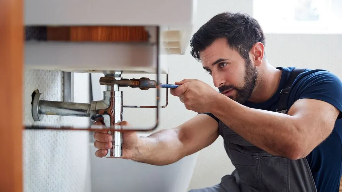 Plumbing repair work in progress in Clapham kitchen