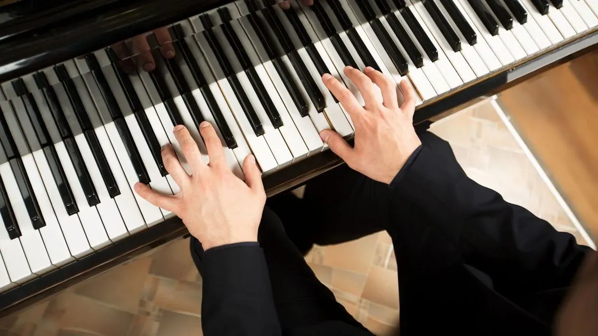 Child practicing piano at home in Chadwell St Mary