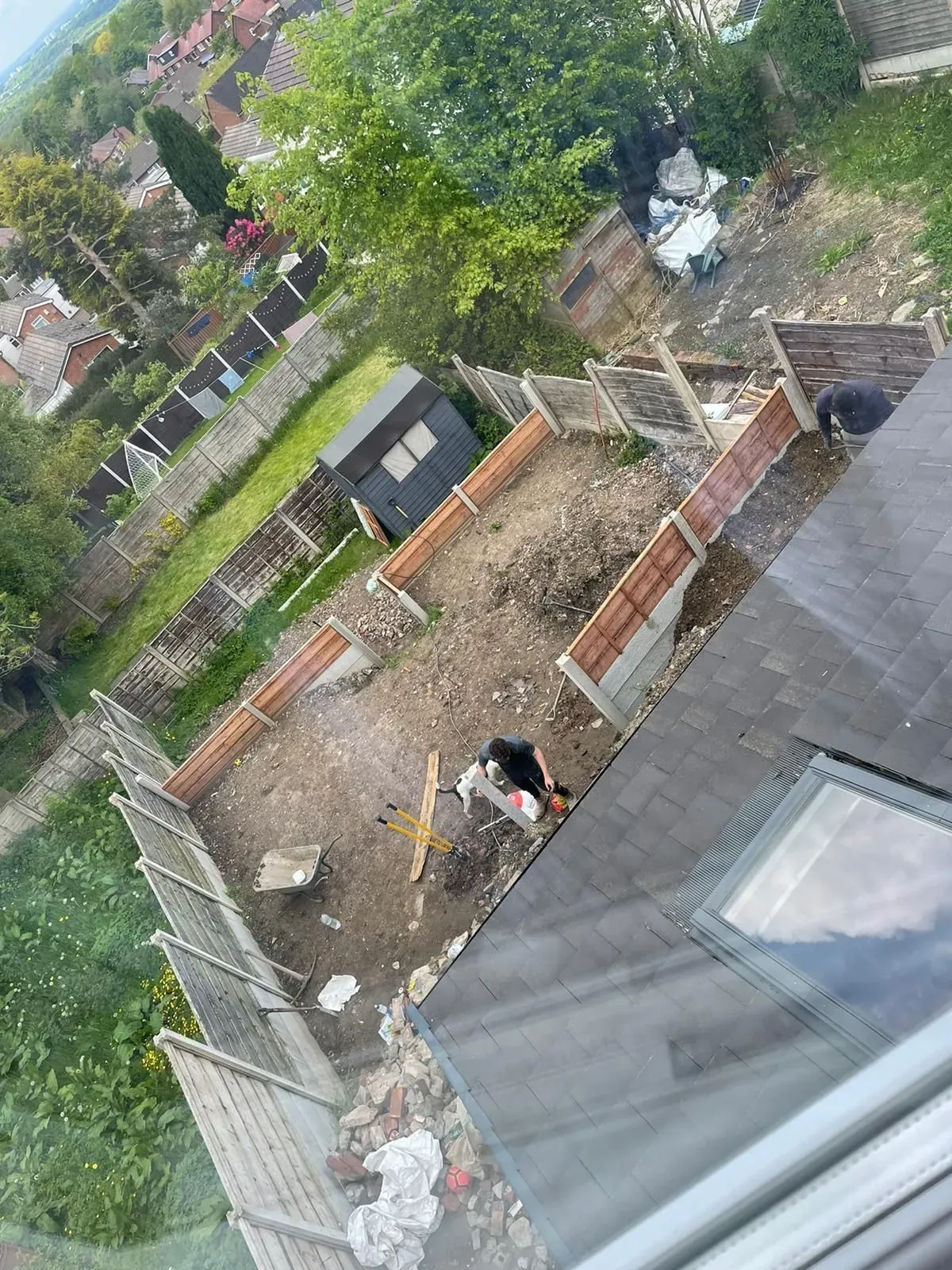 Local handyman repairing a fence in Marple garden