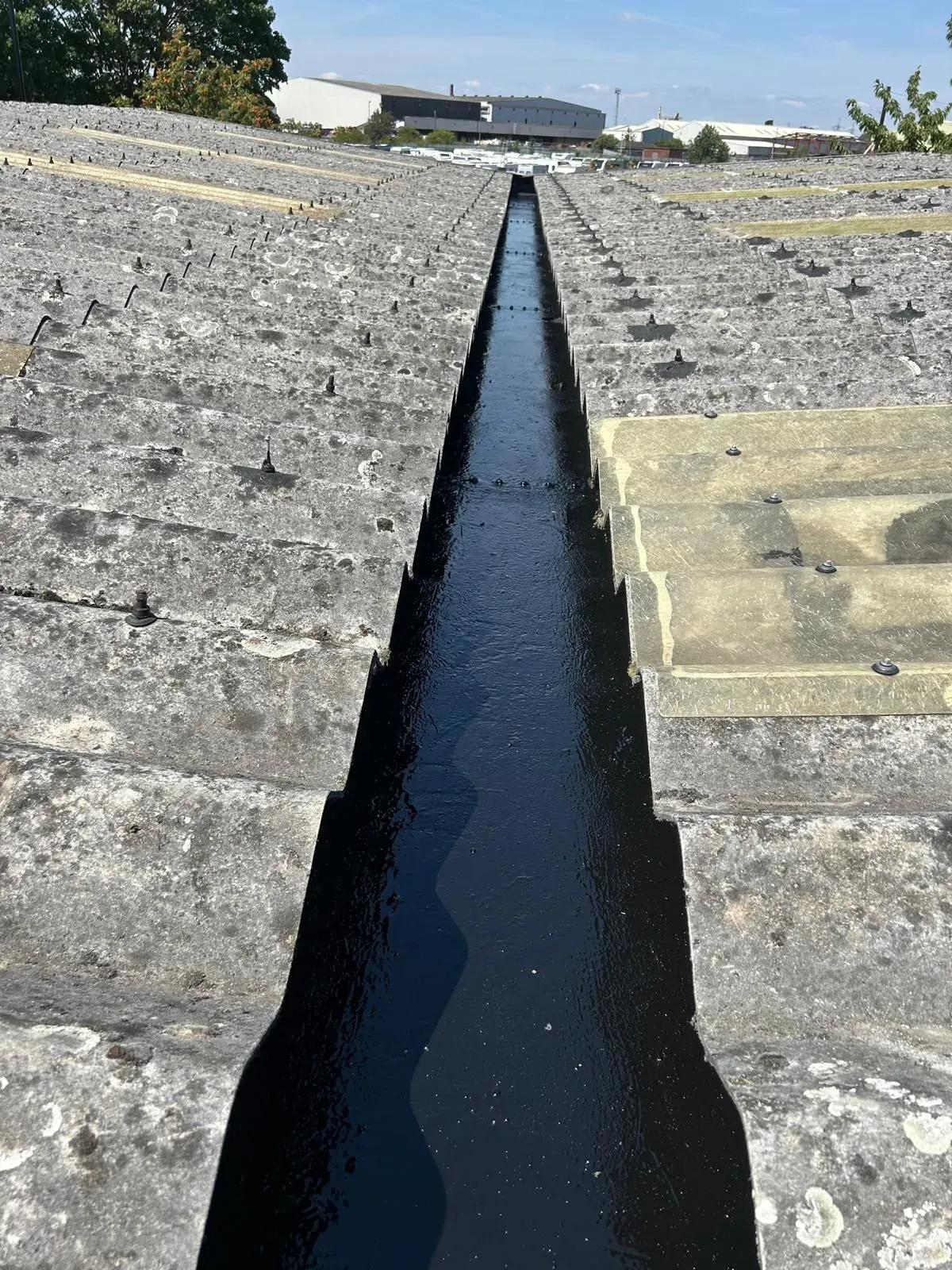 industrial gutter clean and asbestos sealer applied for longer lifespan