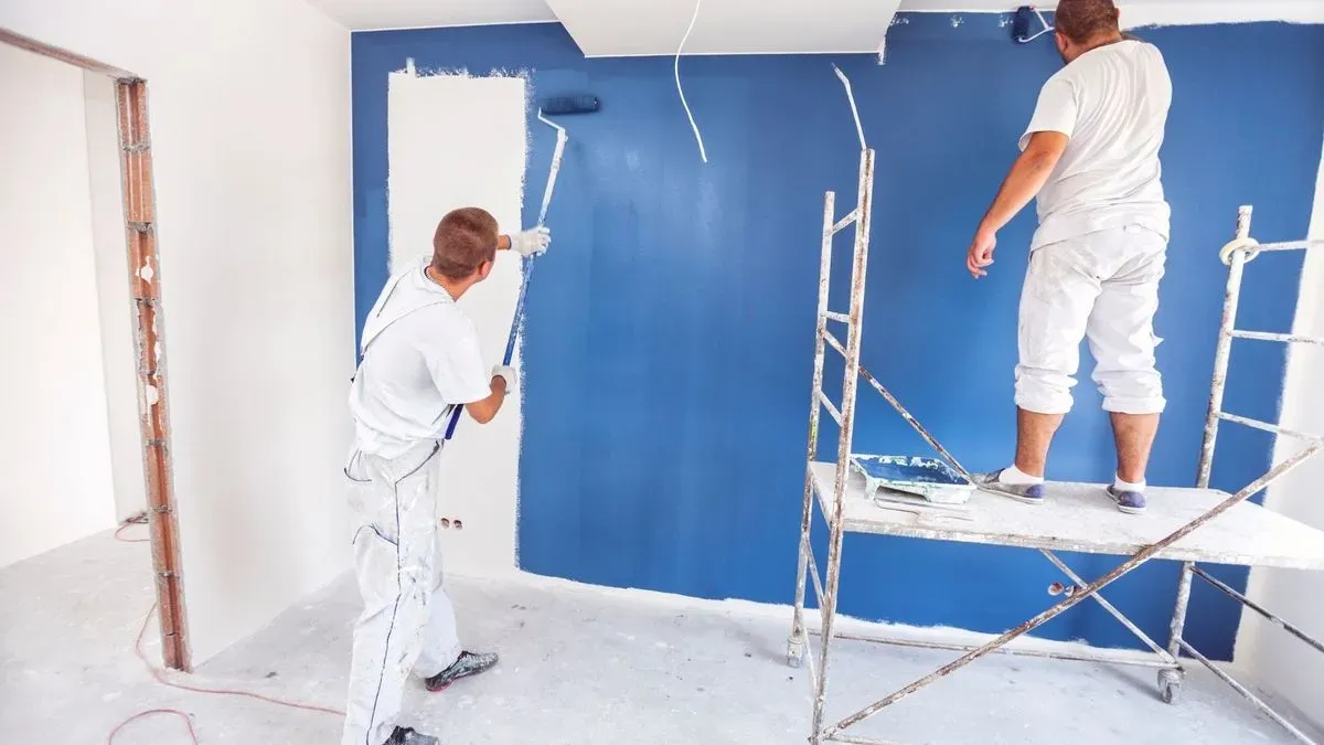 Professional painter discussing colour options with customer in Stanmore