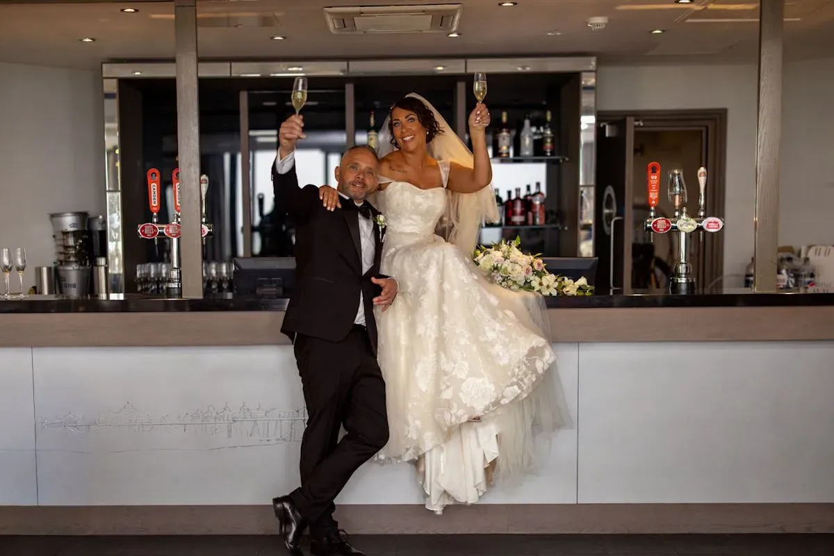 Bride and groom celebrating with champagne at The View Hotel Eastbourne