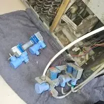 Technician checking electrical connections for a tumble dryer