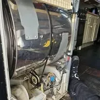 Technician carefully installing a washing machine in Stanford le Hope