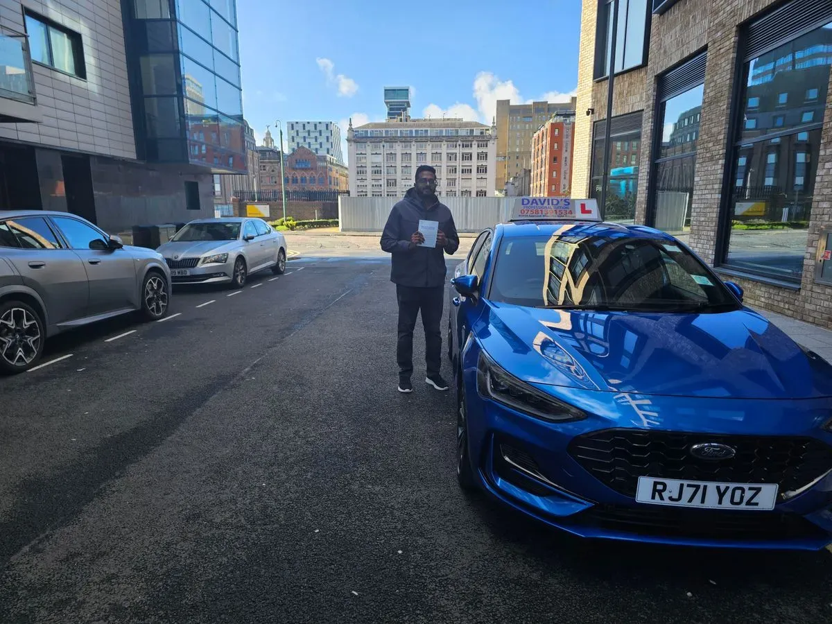Instructor providing guidance during manual driving lesson