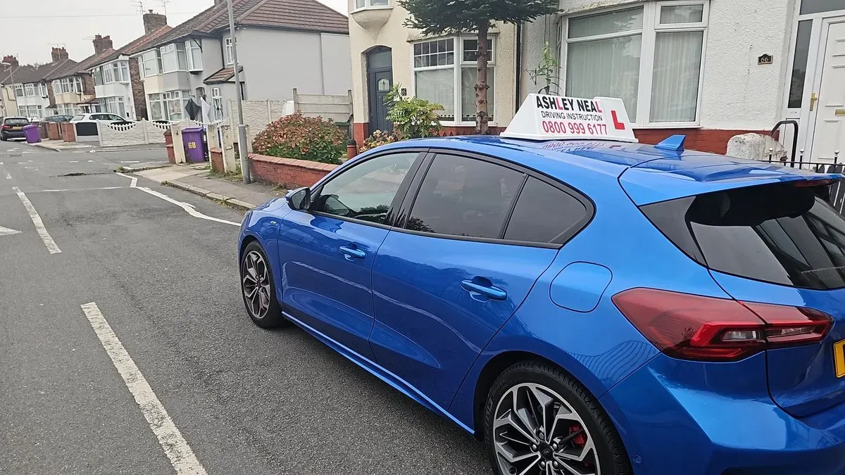 Happy student celebrating passing their driving test in Kirkdake