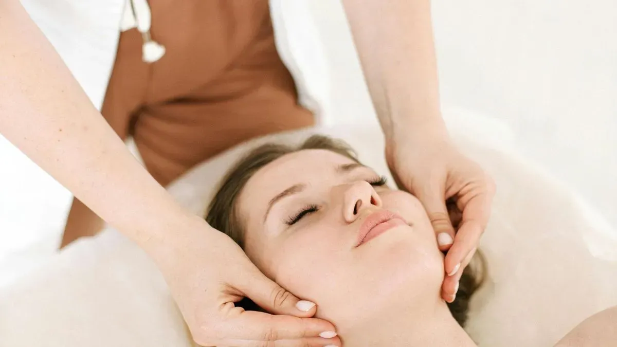 Happy client enjoying face massage experience in Trouton