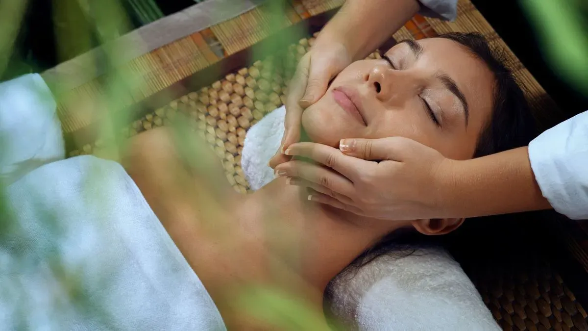 Skilled therapist providing face massage in Trouton