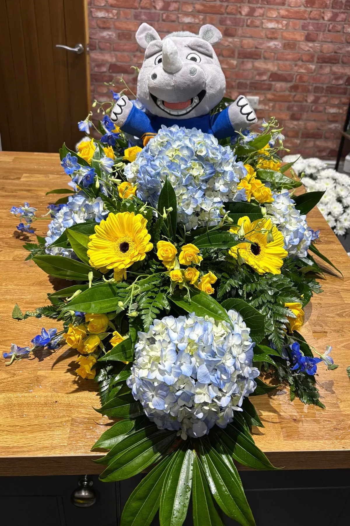 Caring team arranging floral tributes in Bingley