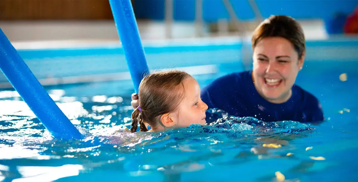happy family enjoying swimming classes in new romley