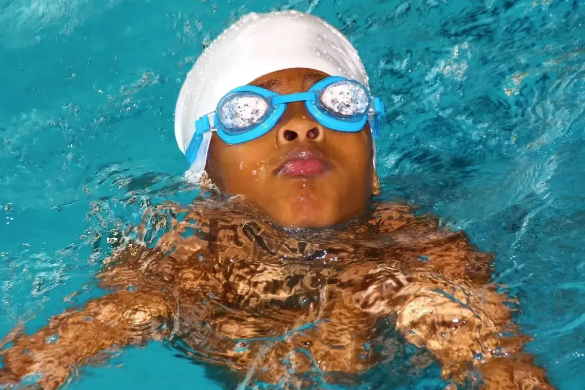 successful swimmer emerging from water in new romley