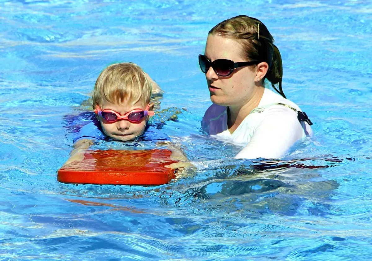 group of kids having fun during swimming lesson in new romley