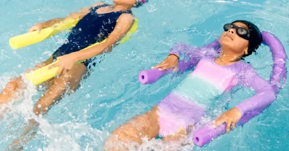Happy adult learner in swimming lesson at New Romley