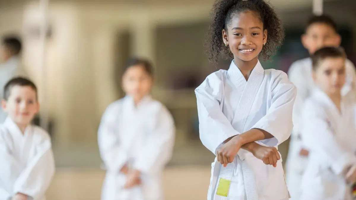 Karate instructor guiding children in Stanwell class